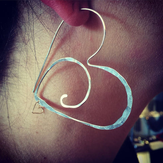 large silver heart hoops with gold heart charm detail